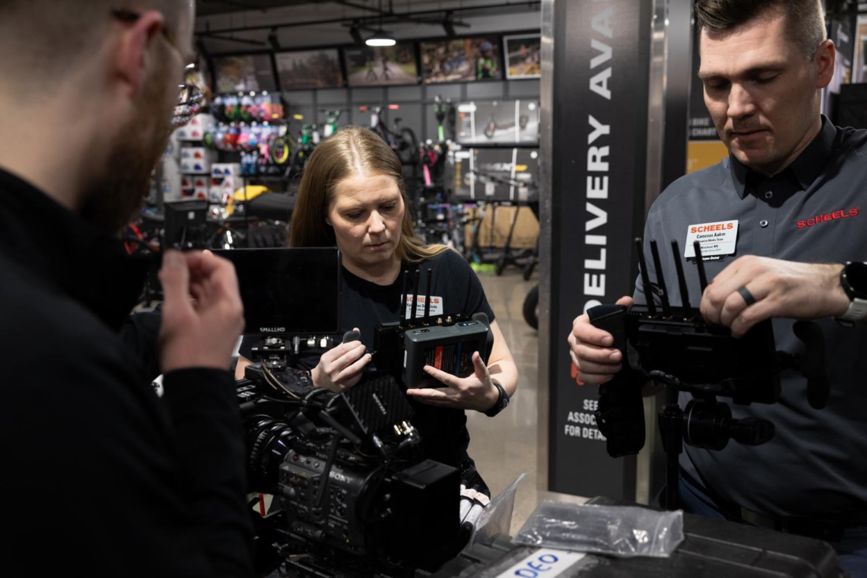 Kylie Van Den Einde and Cameron Aakre setting up video equipment