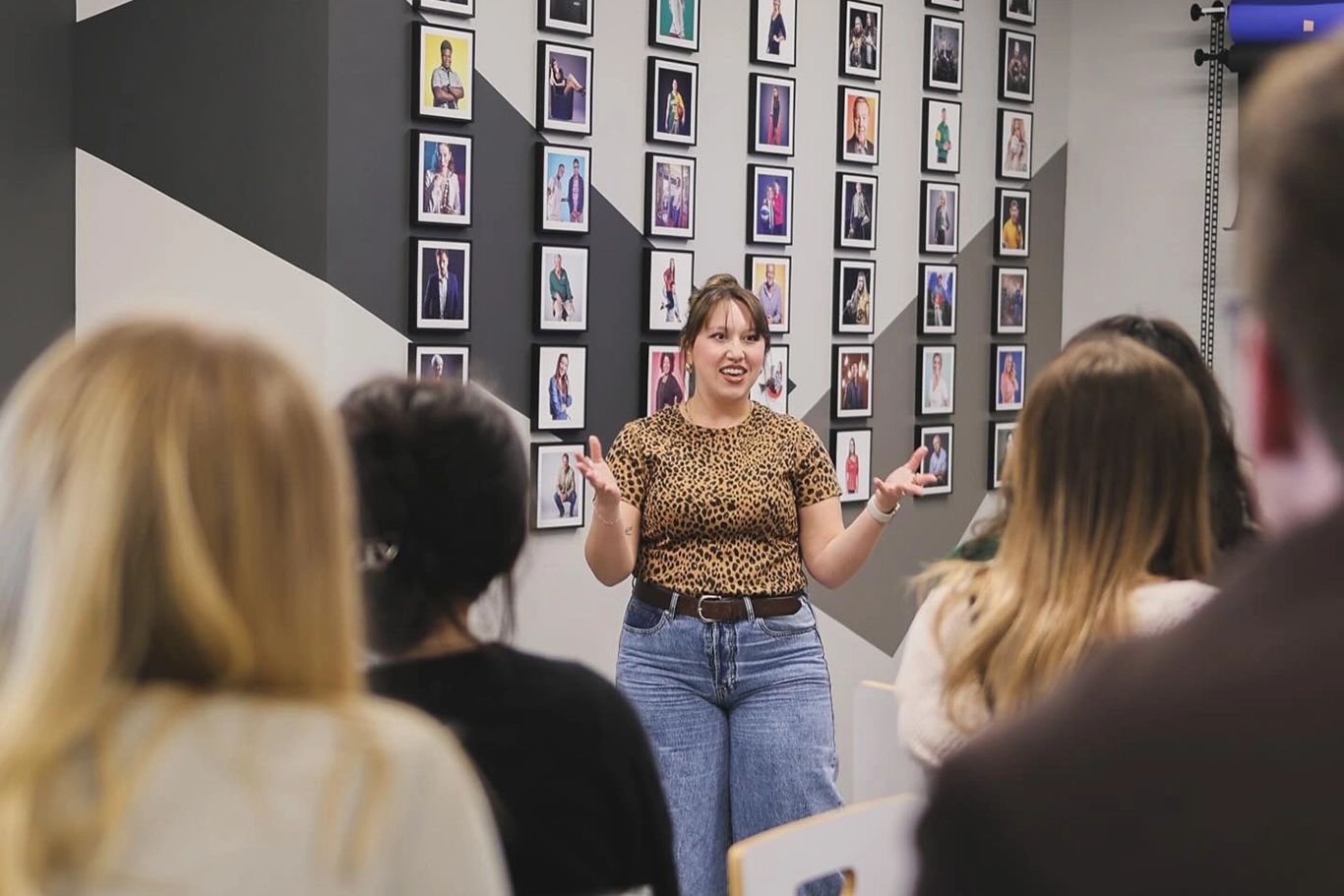 Geneva speaking in front of a group of people