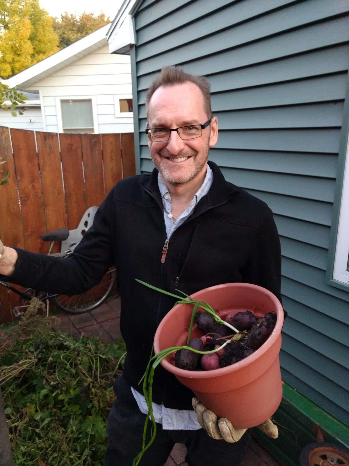Dr. Marry with vegetables grown in his home garden