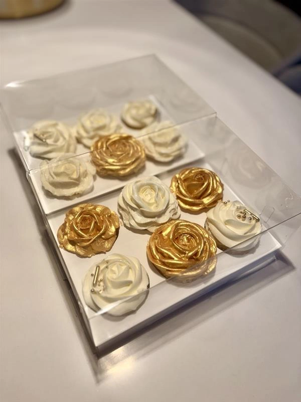 White and Gold Cupcakes on a tray.